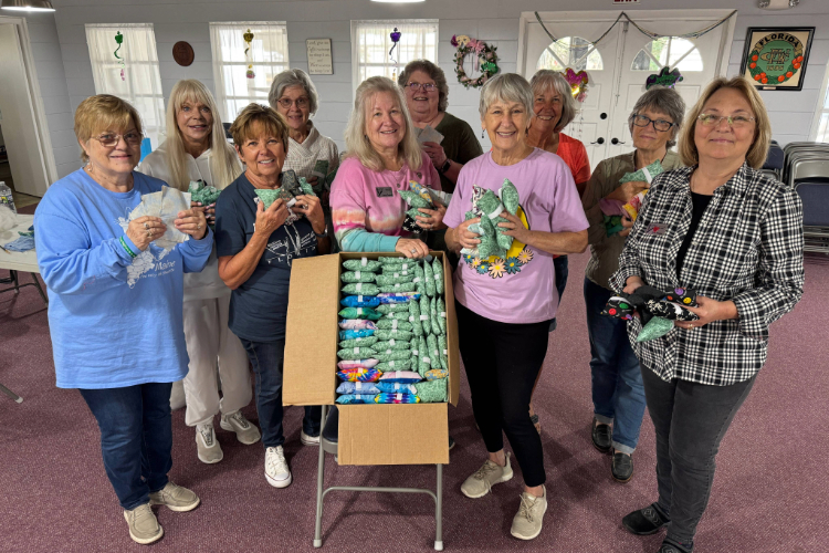 Volunteers sewing port pillows together