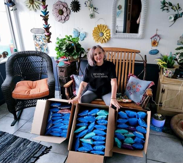 A cancer warrior holding her Chemo Care Kit